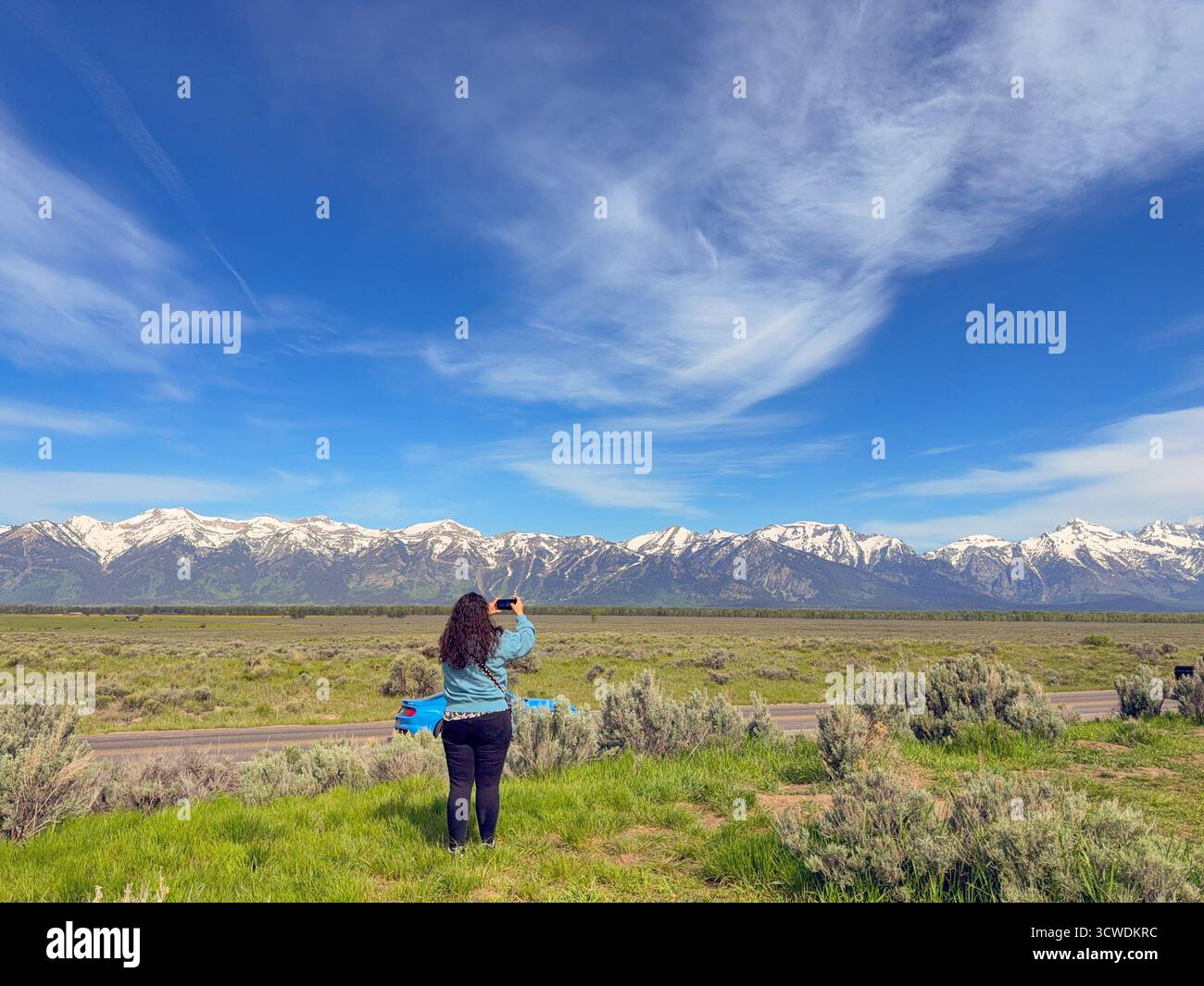 Jackson, Wyoming, USA - 28 may 2025: Person using a mobile phone to take a picture of the stunning landscape in the Grand Teton National Park - Smartphone Captured Stock Image