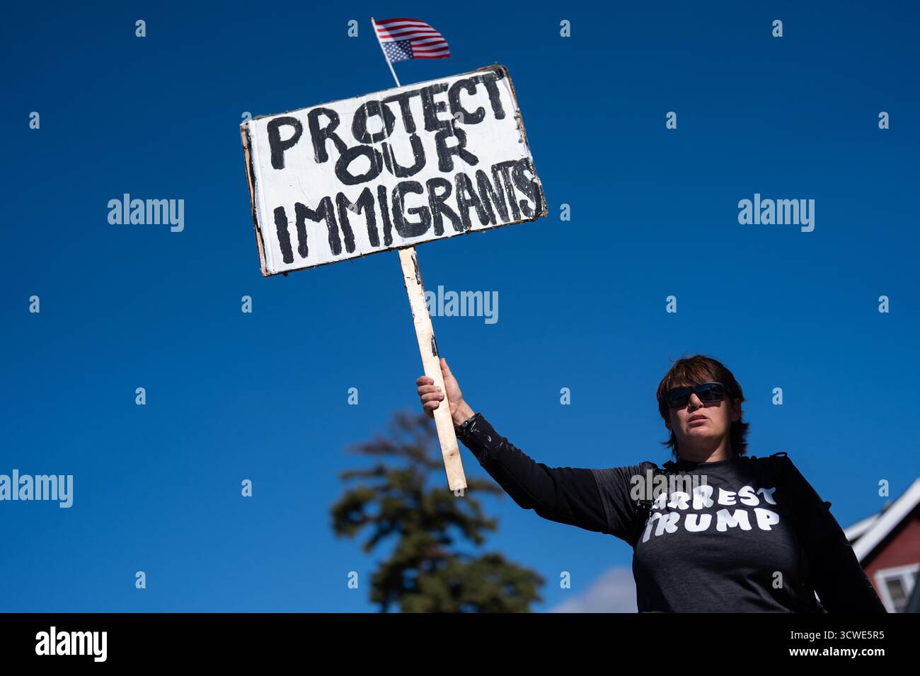 A protestor holds a sign outside the U.S. Immigration and Customs ...
