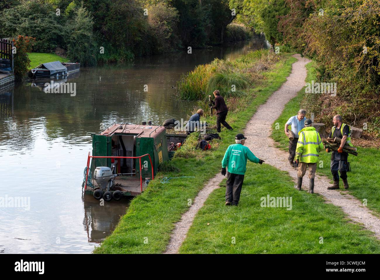 Odiham Hampshire England UK. 11.10.2025. Overview of workboat and voluteers working  beside the Basingstoke Canal at Odiham Hampshire UK.alongside Stock Photo