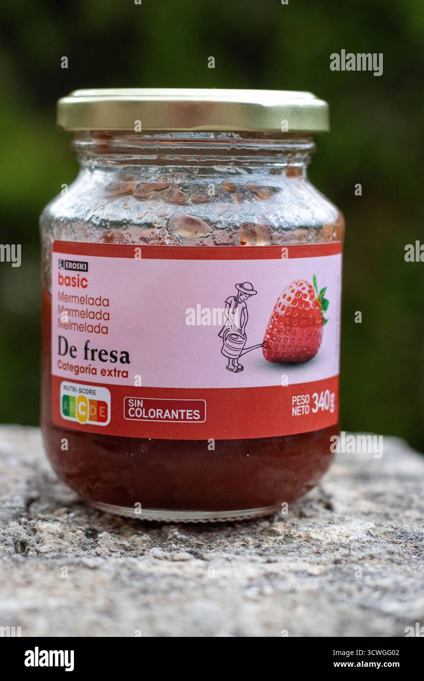POLLENSA, MALLORCA, SPAIN -  SEPTEMBER 13, 2024 opened glass jar of Eroski basic Marmelada de fresa close up isolated product taken outside with a nat Stock Photo