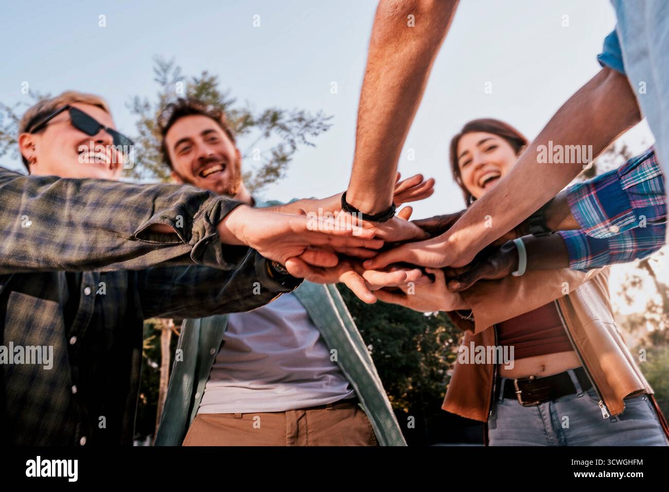 Huddle hands together support hi-res stock photography and images - Alamy