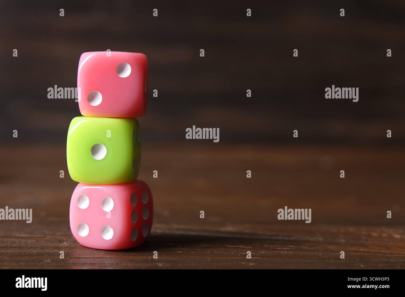 Stack of different game dices on wooden background Stock Photo