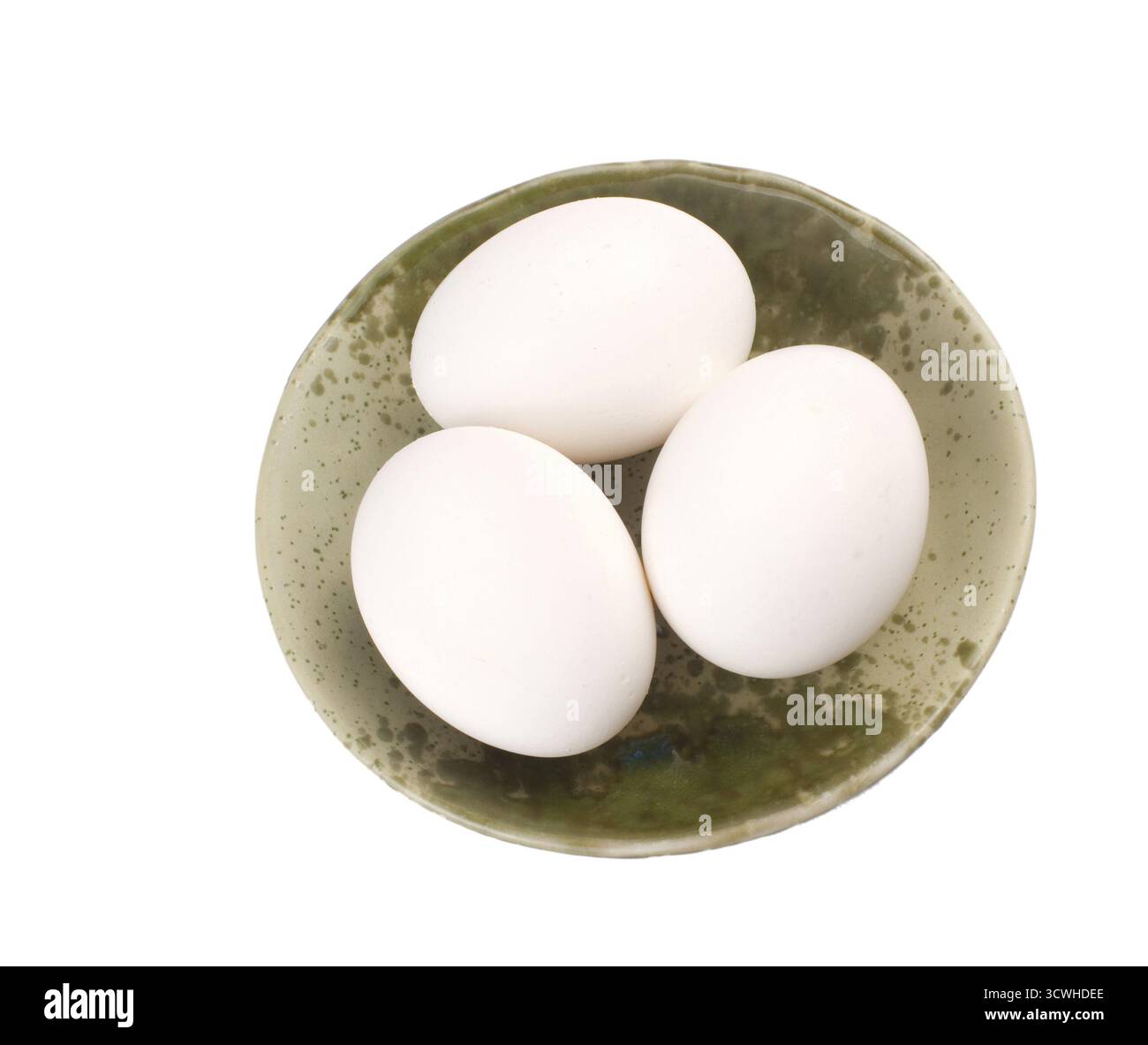 Three eggs in brown bowl, isolated on white background Stock Photo