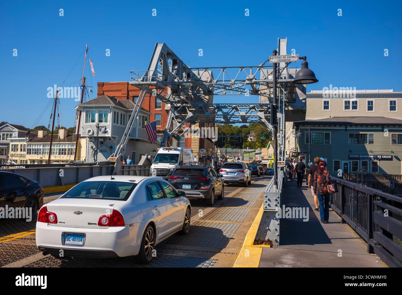 Mystic, CT, USA - Oct 5, 2025: Tourists cross the Mystic River Bascule Bridge that spans over the Mystic River.  The seaport village  is known for its Stock Photo