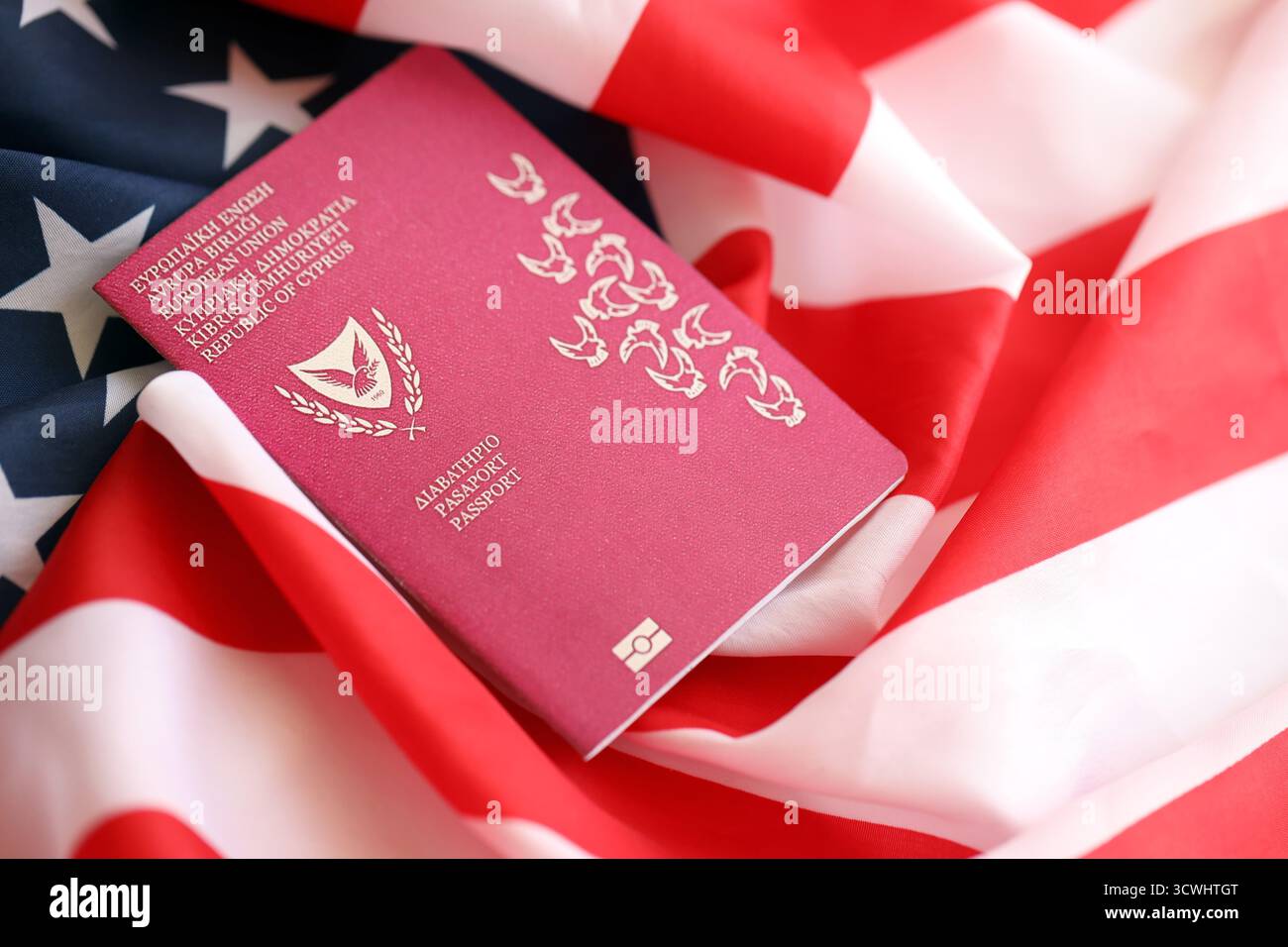 Kyprus passport on big waving flag of United States of America close up. US Visa and immigration concept Stock Photo