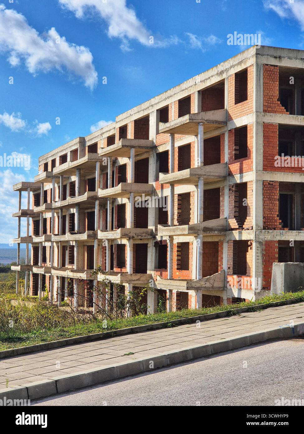 Construction phase of a brick apartment complex. Residential building under construction. - Smartphone Captured Stock Image