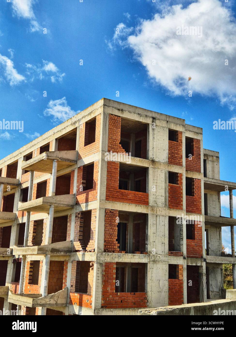 Construction phase of a brick apartment complex. Residential building under construction. - Smartphone Captured Stock Image