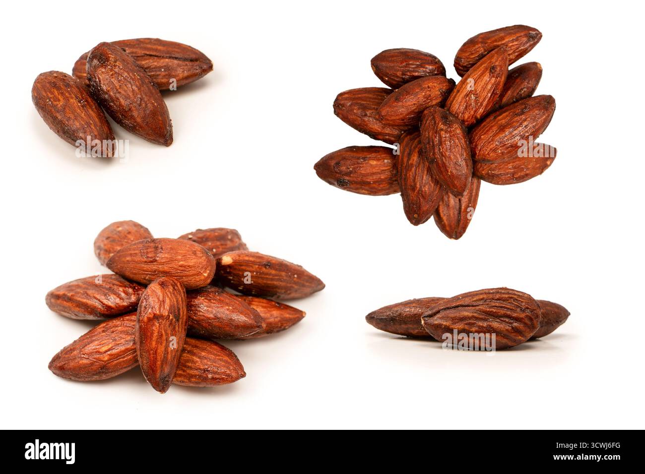 A group of caramelized almonds isolated on a white background. Stock Photo