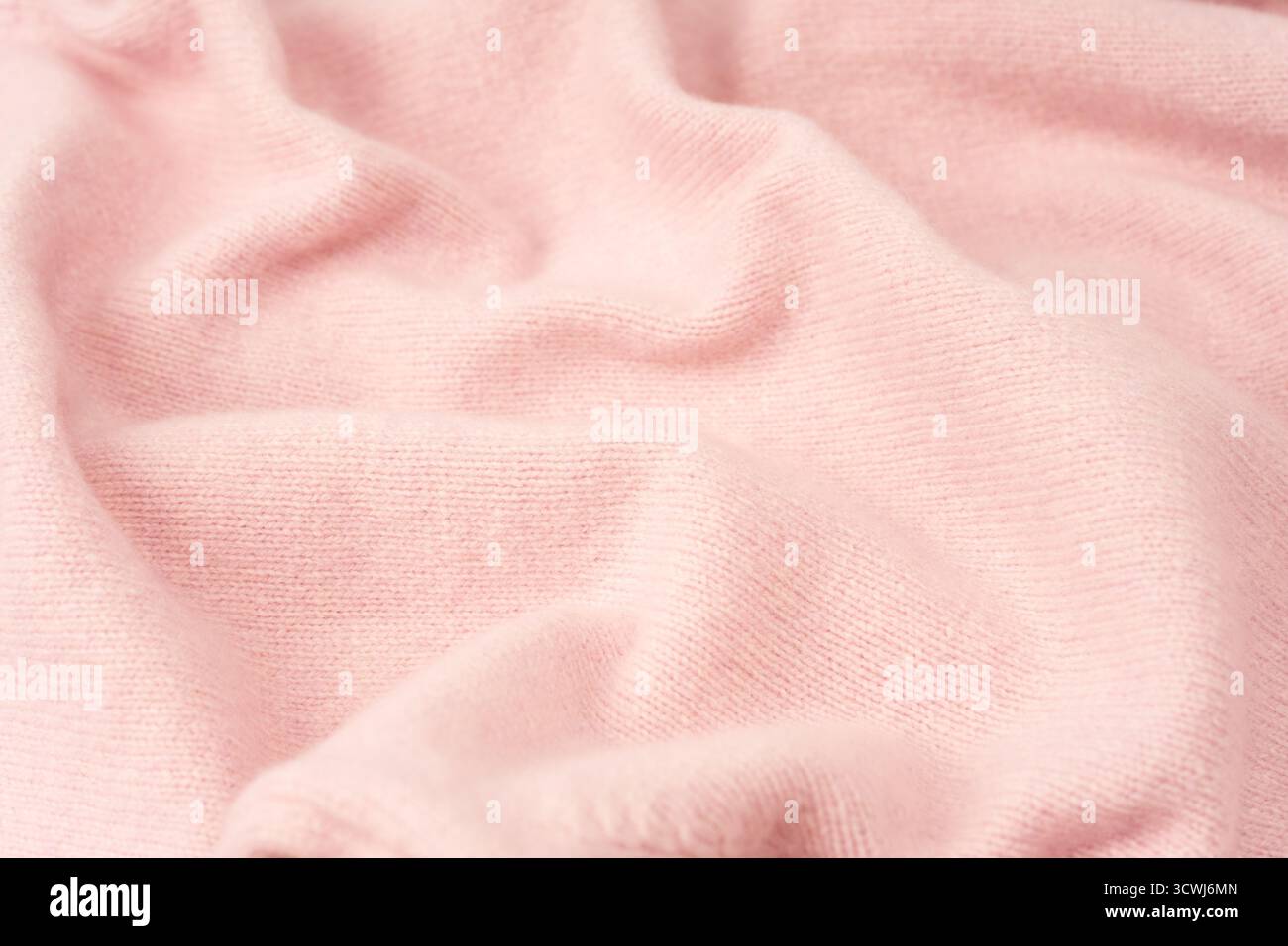 Soft pink cashmere sweater texture background. Top view. Stock Photo
