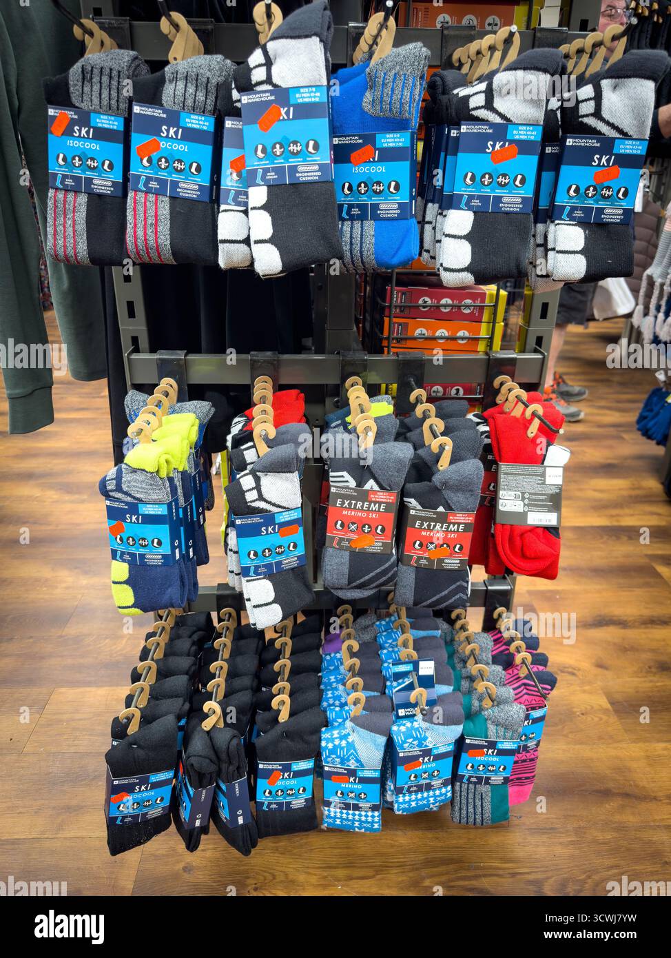 Display of colourful, assorted ski and thermal socks hanging on a rack in a retail clothing store - Smartphone Captured Stock Image