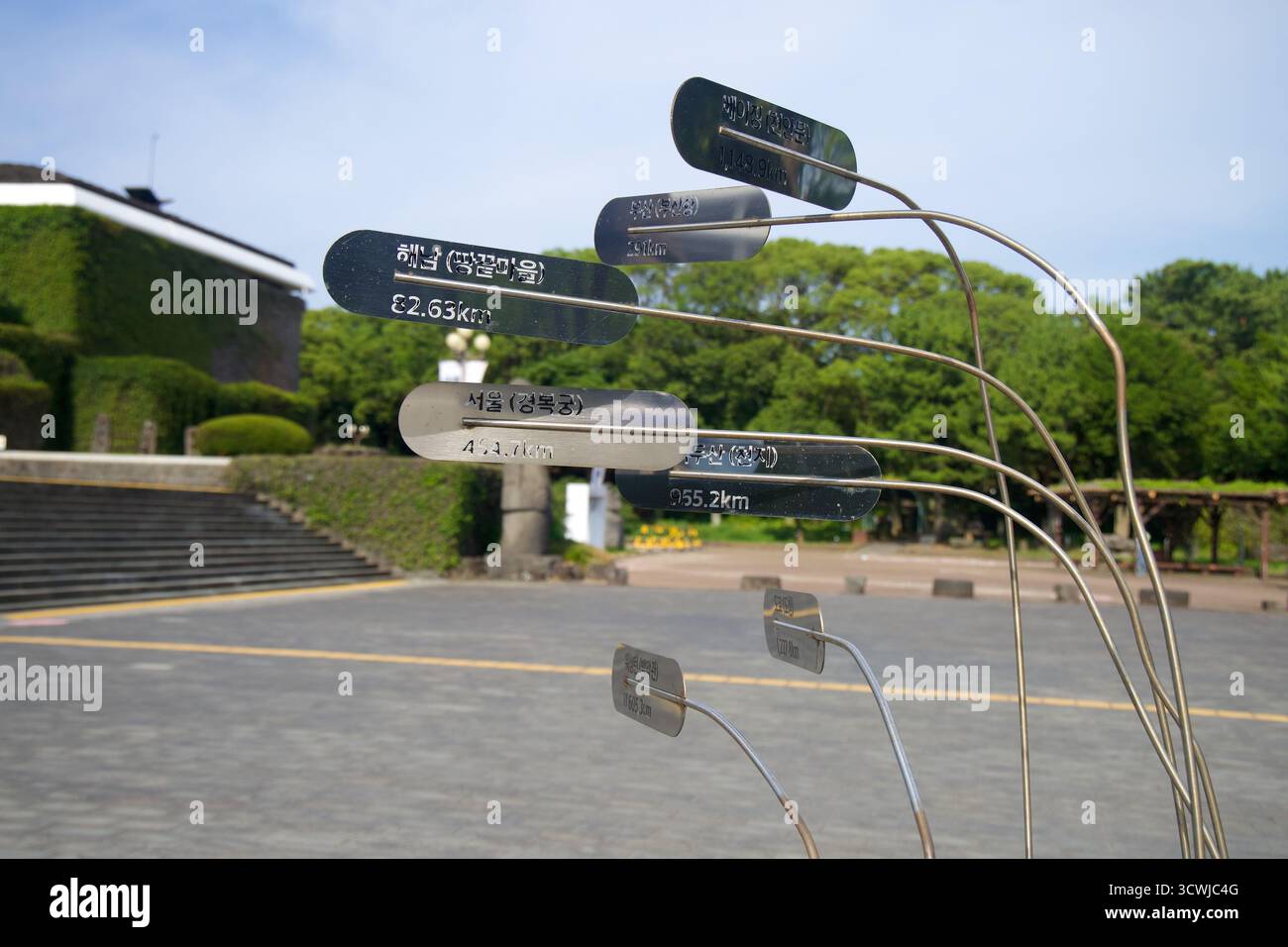 Curved stainless-steel direction signs etched with Korean place names ...