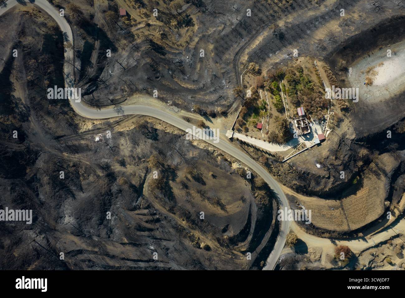 Parched ground shows the aftermath of a devastating wildfire that swept ...