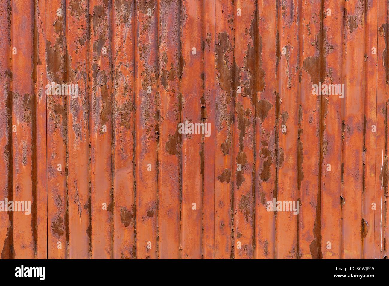Rusty vertical corrugated metal sheet Stock Photo