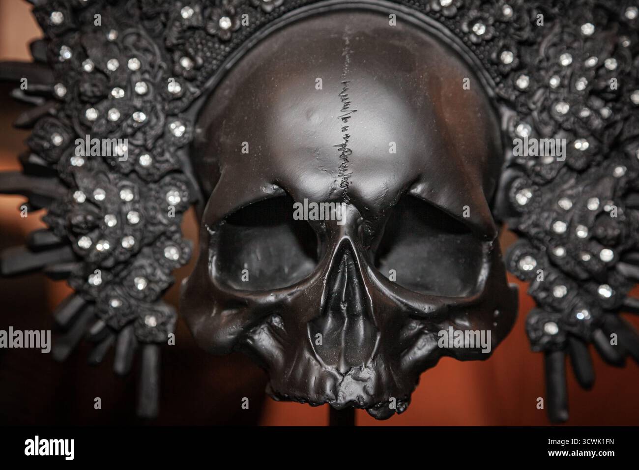 An ancient human skull adorned with a golden diadem with diamonds Stock Photo