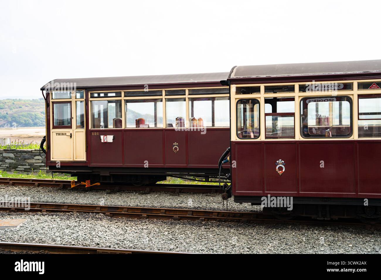 Historic narrow gauge railway carriages at lakeside station in maroon and cream livery Stock Photo