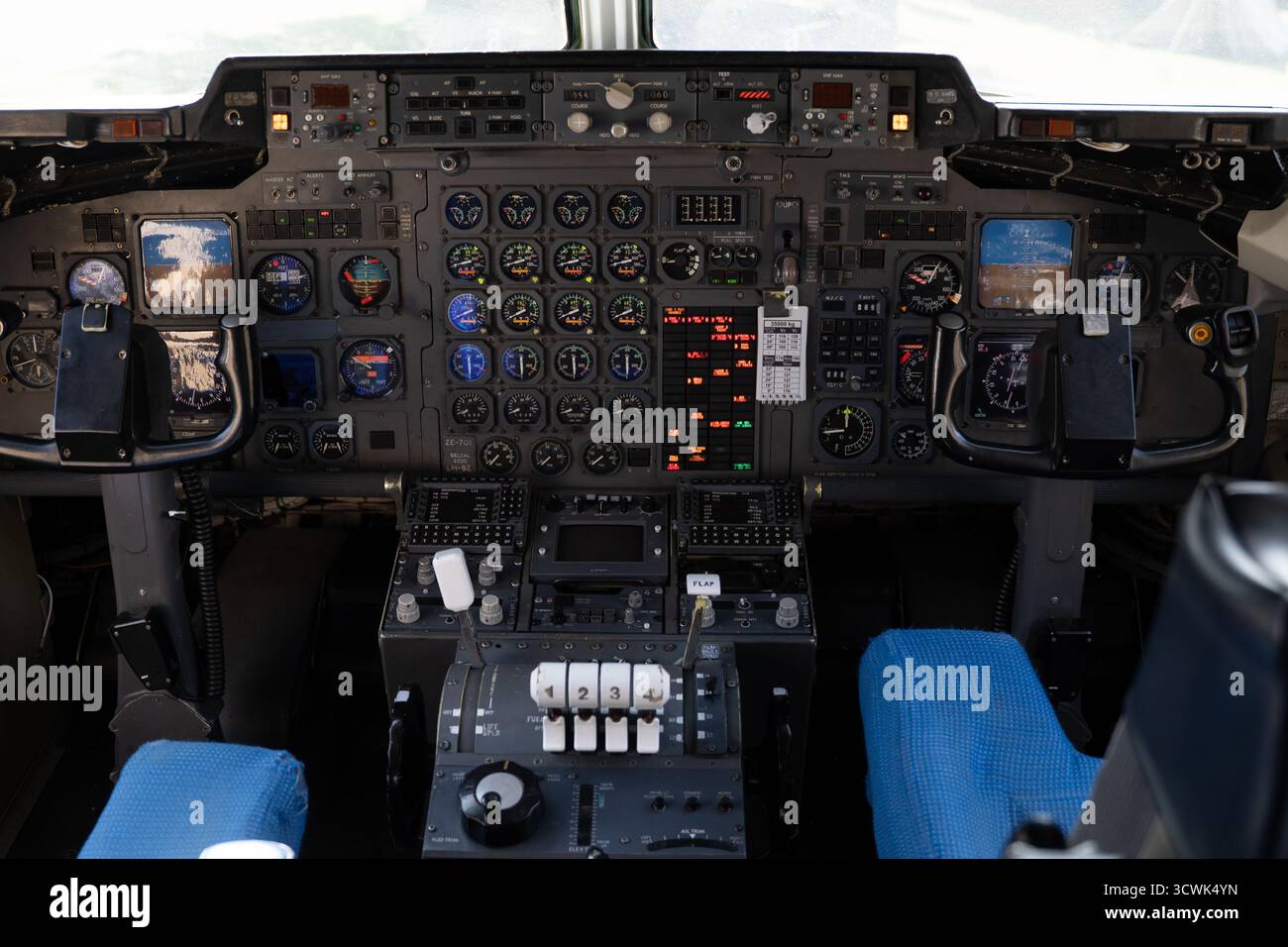 Aircraft cockpit with complex instrument panel and flight controls at ...