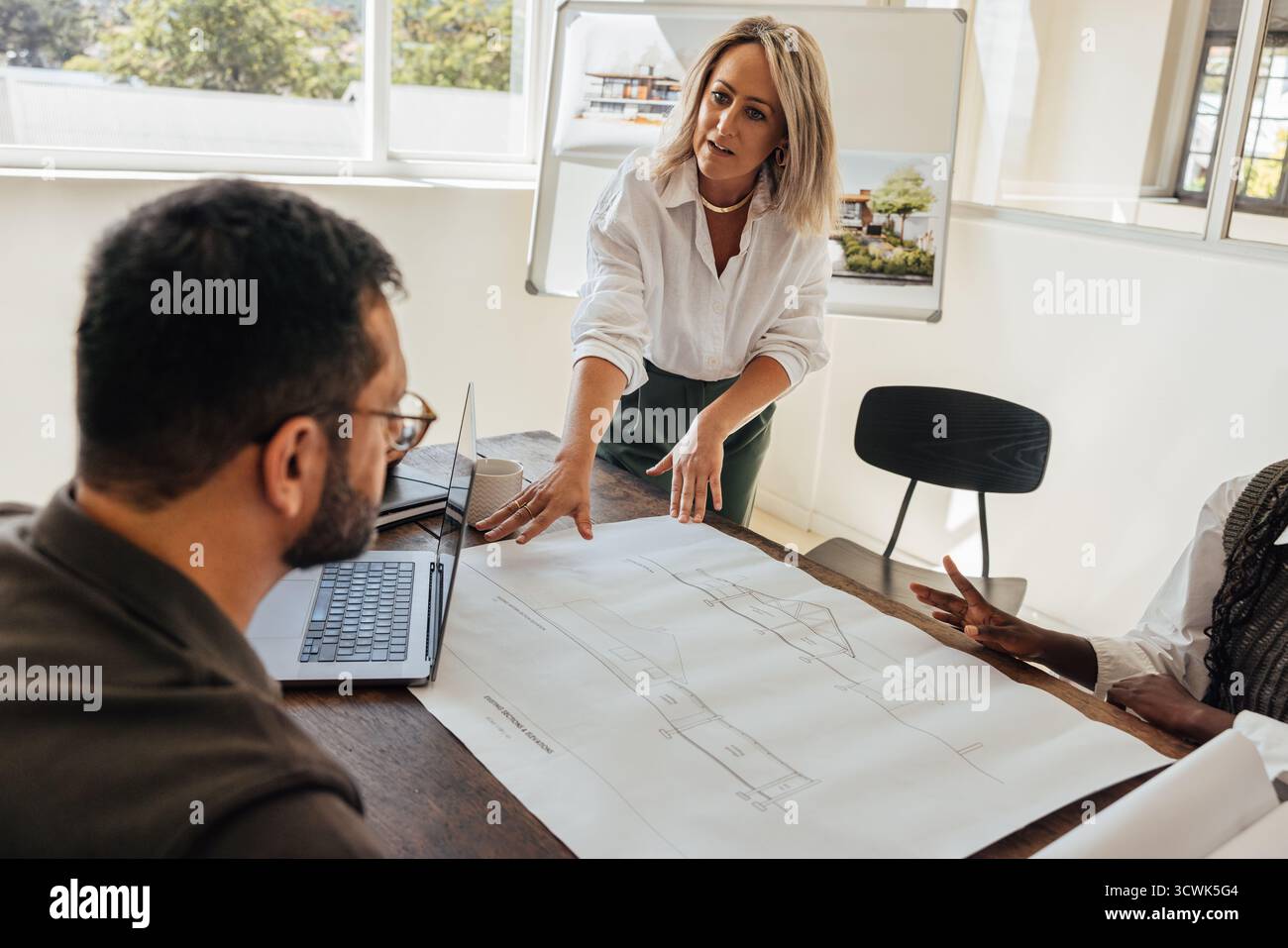 Professional architects collaborating reviewing building hi-res stock ...