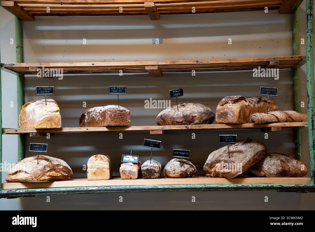 Bread loaves on a shelf in a bakery and pastry shop Stock Photo - Alamy