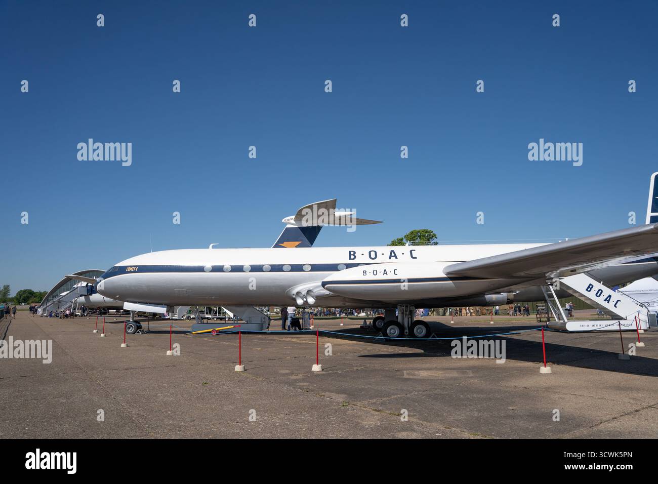 Historic BOAC airliner on display at aviation museum under clear blue sky Stock Photo