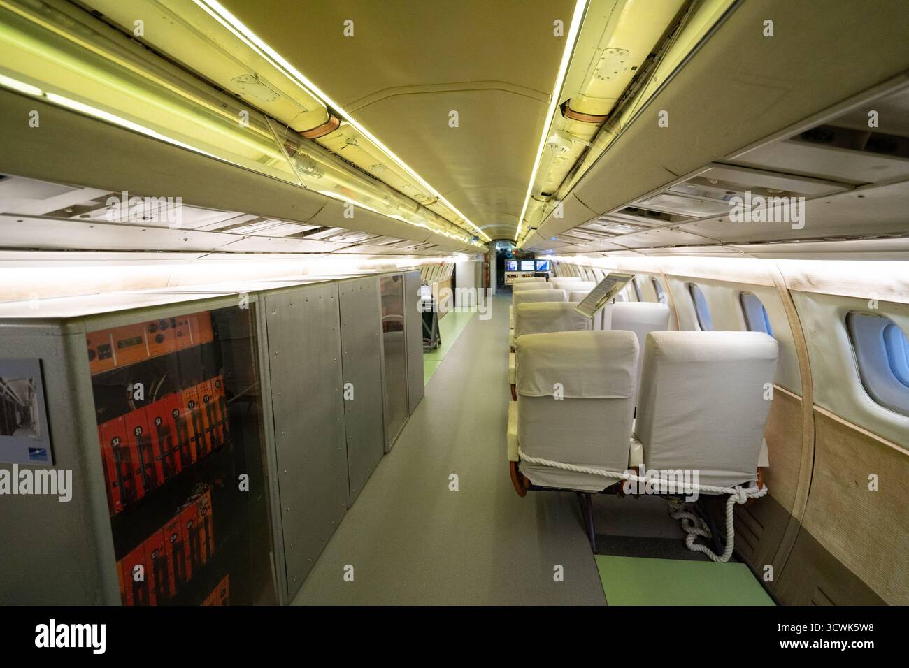 Interior view of vintage passenger aircraft cabin showing seats and windows Stock Photo