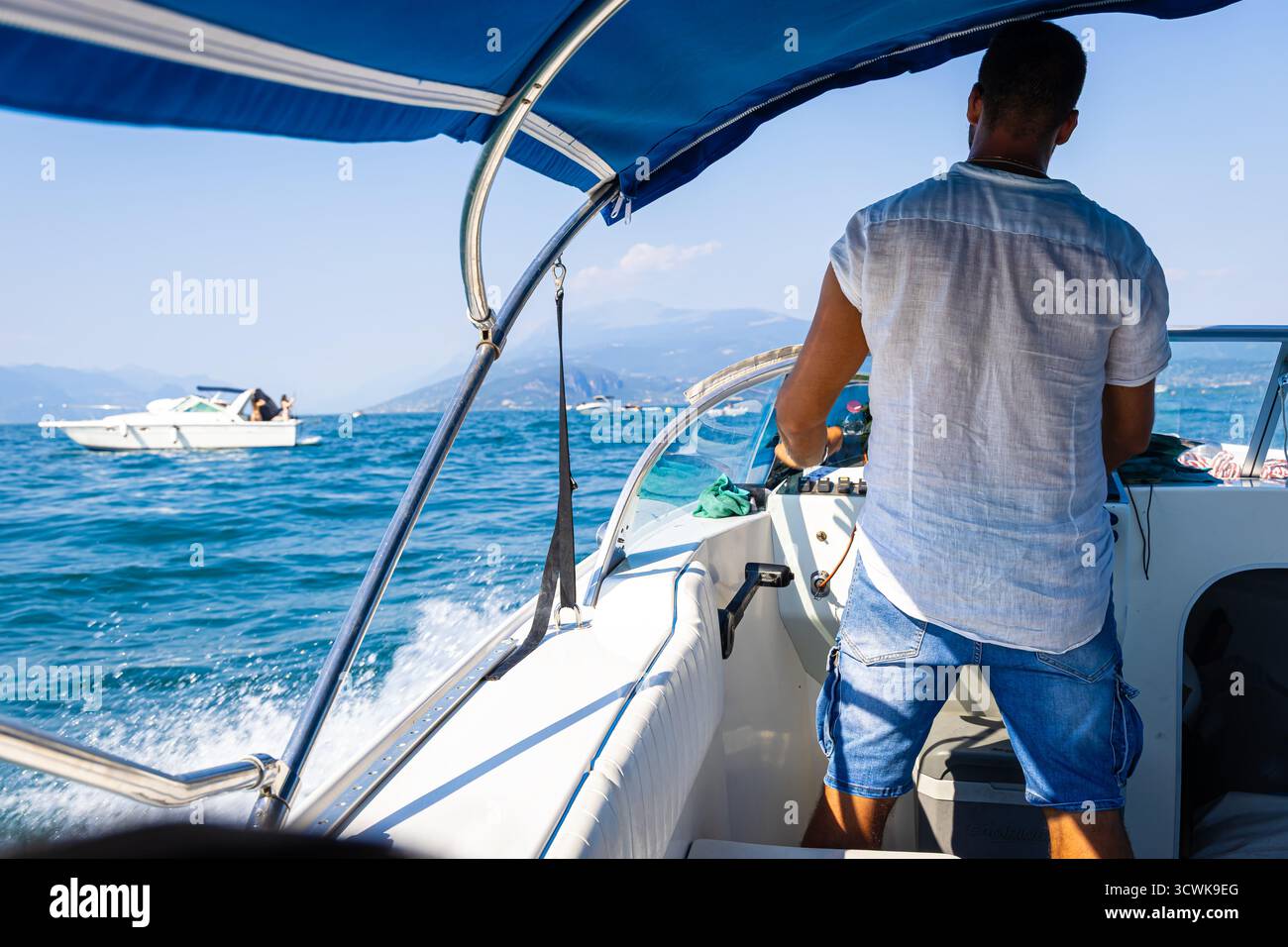 The boat driver on lake Garda Castle in Sirmione, Italy, Europe Stock ...