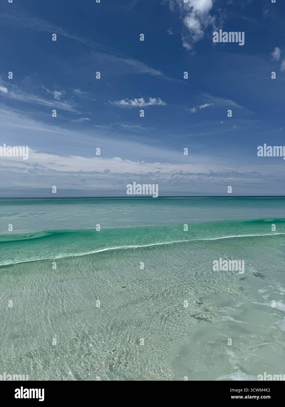 Crystal clear emerald colored water of the Gulf of Mexico Florida with rolling wave - Smartphone Captured Stock Image