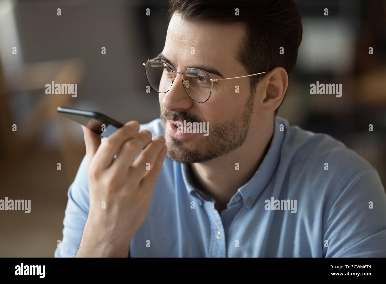 Closeup portrait young businessman speaking on phone using voice app Stock Photo