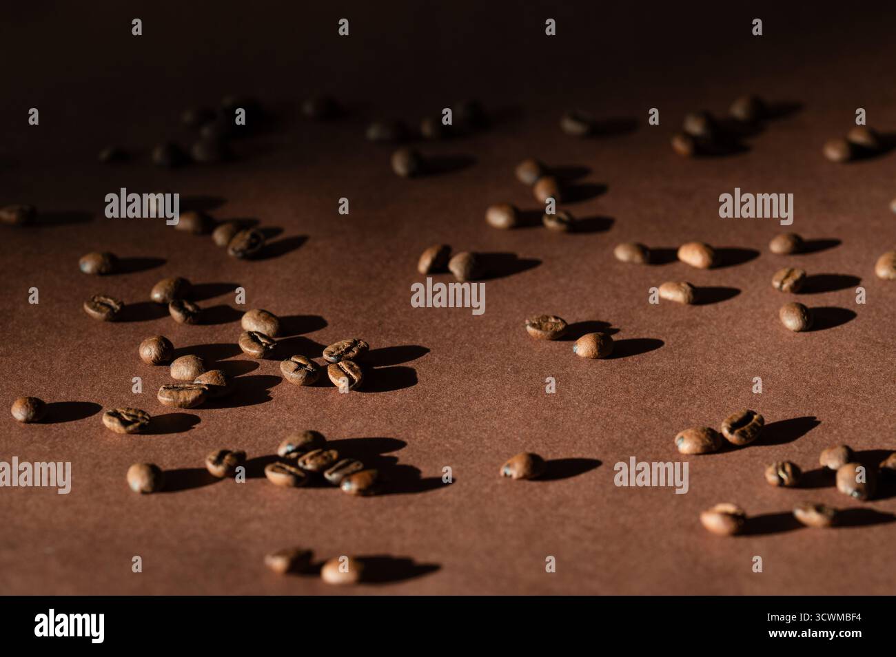 Whole, roasted coffee beans on blown background Stock Photo
