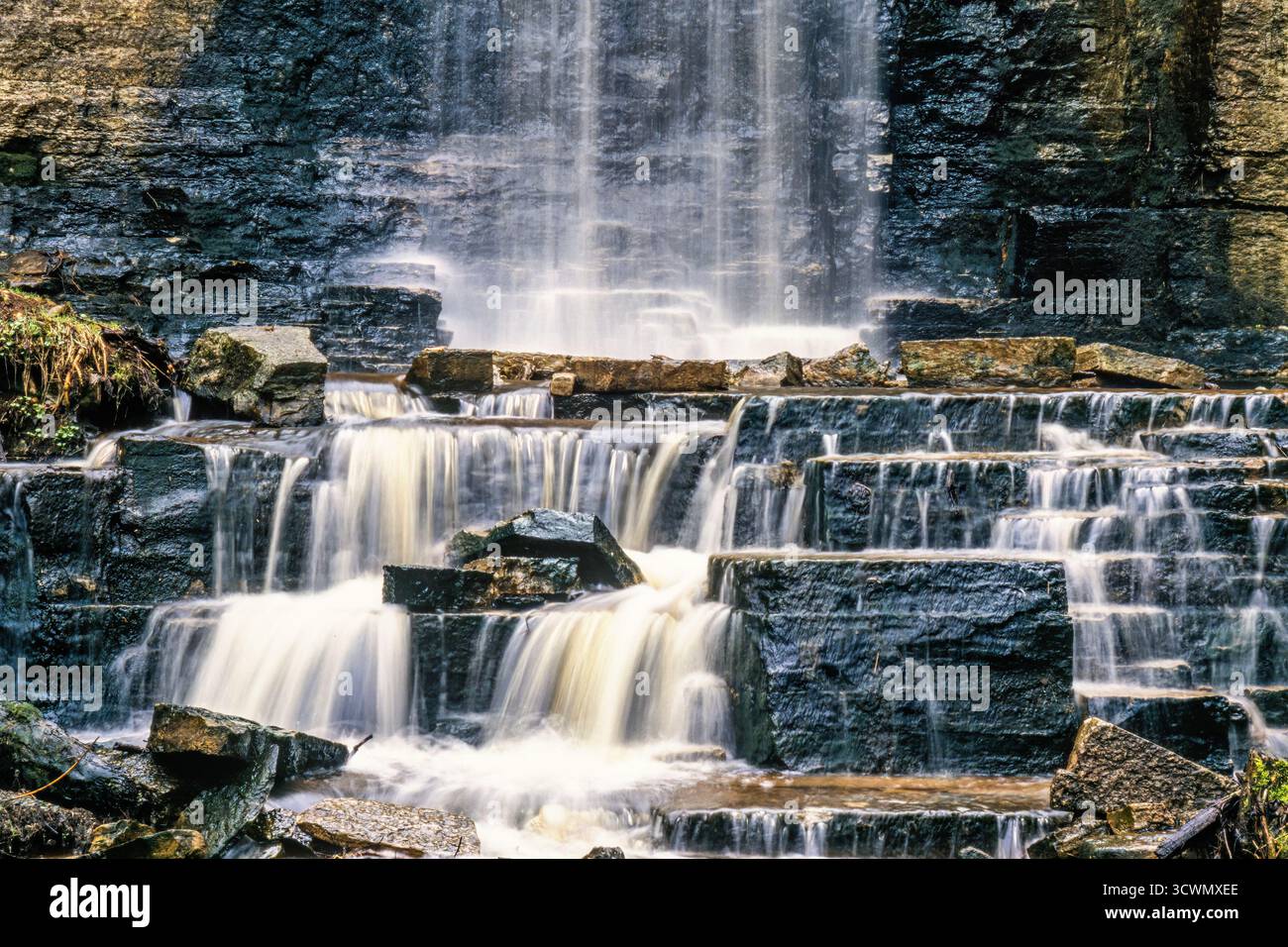 Waterfall with flowing water on the rocks Stock Photo