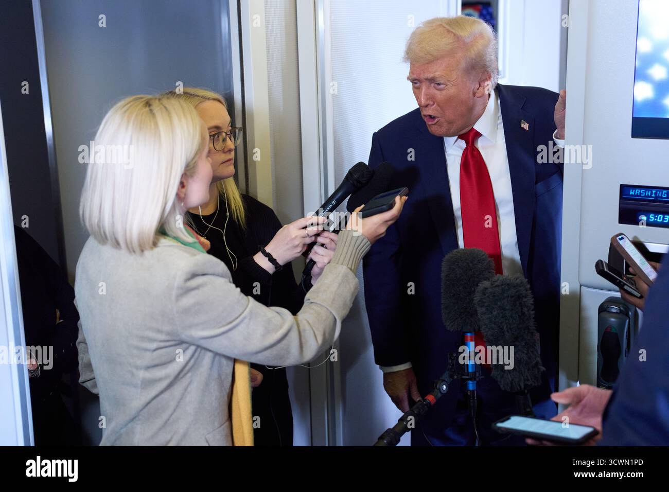 President Donald Trump speaks with reporters aboard Air Force One ...