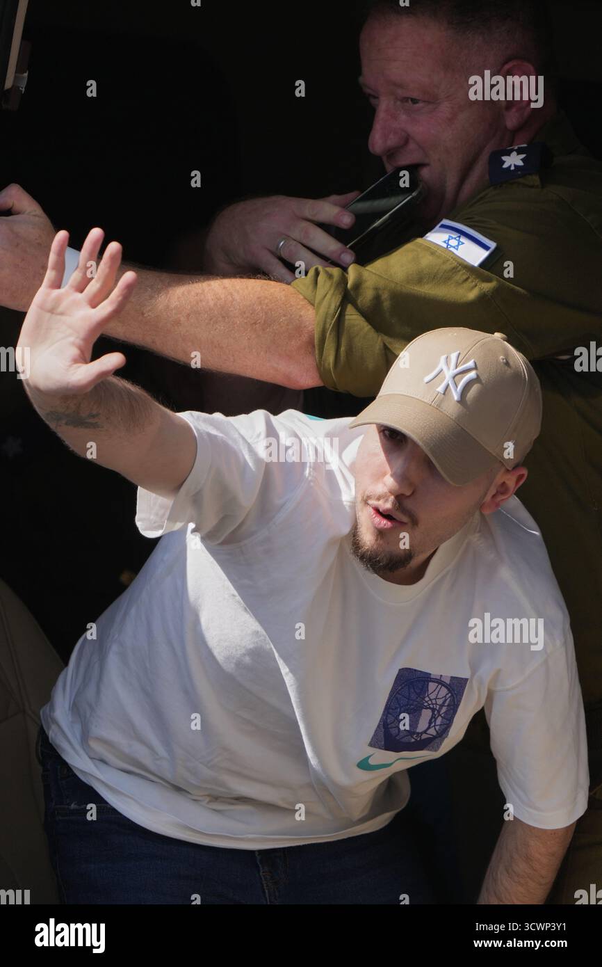 Mor Israeli Freed Israeli hostage Eitan Mor gestures from a van as he arrives at ...