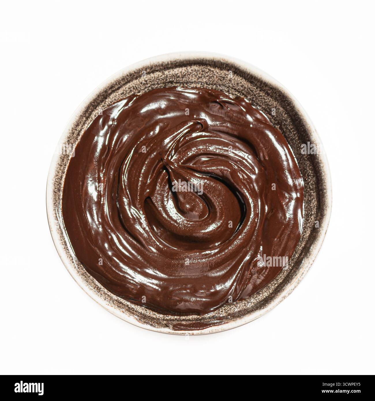 Bowl of melted dark chocolate isolated on white background, top view. Chocolate sauce, design element. Stock Photo
