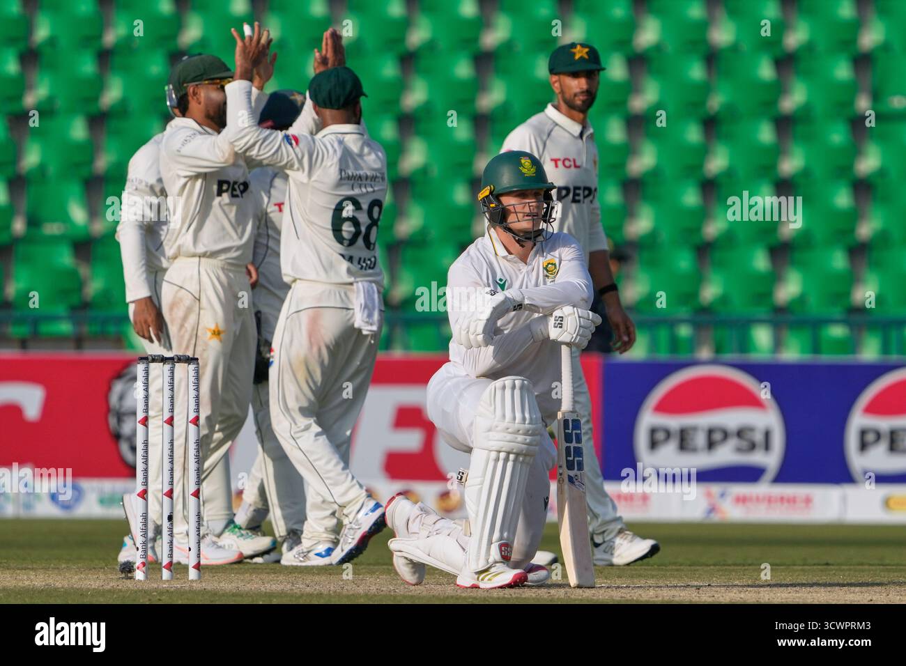 South Africa's Ryan Rickelton, front, reacts as Pakistani players ...