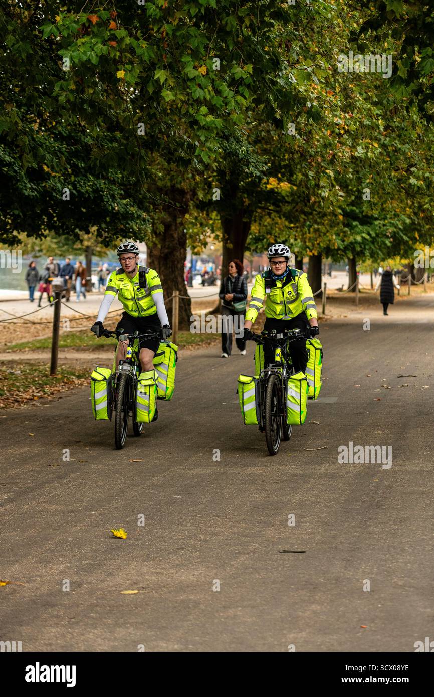 Hyde Park London, Oct 12 2025. Cycle response unit of St John's Ambulance riding through the park, supporting the Royal Parks half marathon. Stock Photo
