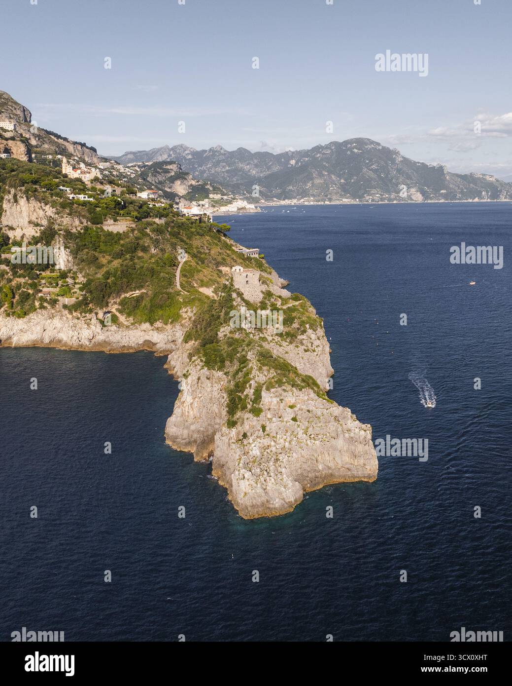 Aerial view of rocky cliffs plunging into the deep blue sea, with the ...