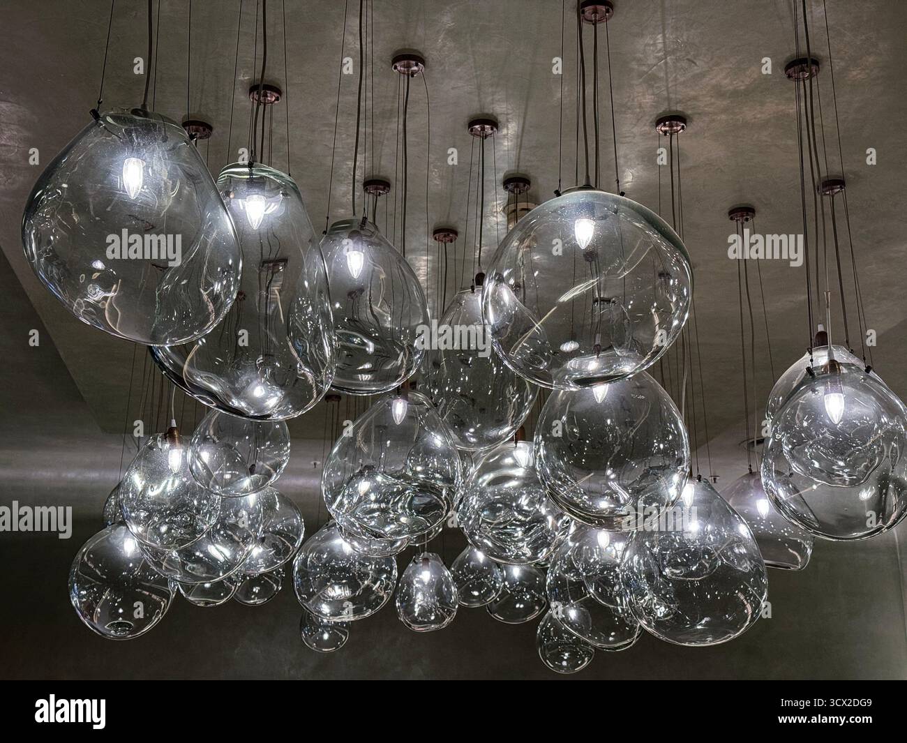 A whole lot of glass lights hanging from a ceiling - Smartphone Captured Stock Image