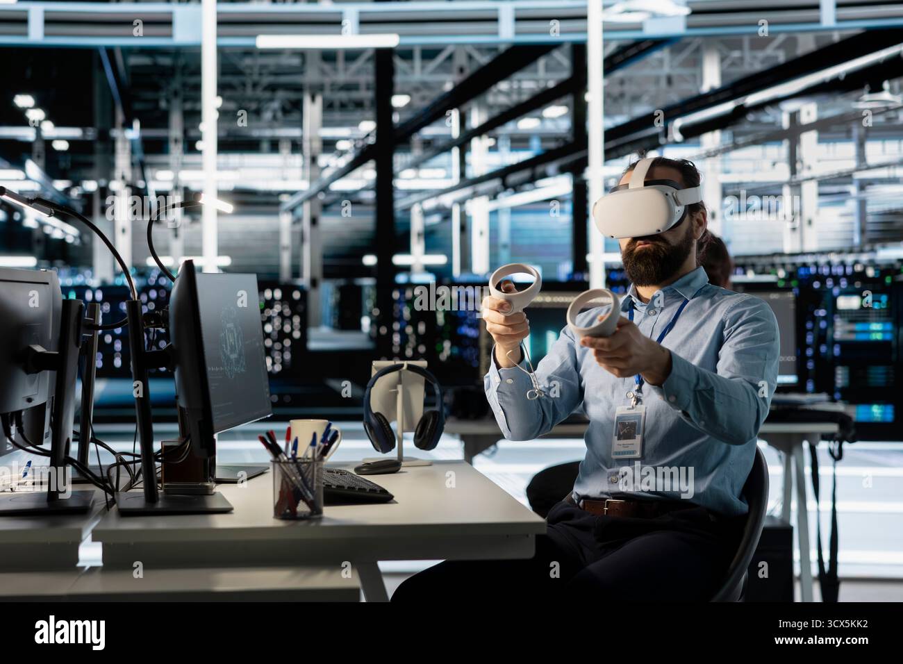Technician using VR headset in data center to update server tech, configuring equipment using software tools. Server room employee reviewing hardware analytics using virtual reality Stock Photo