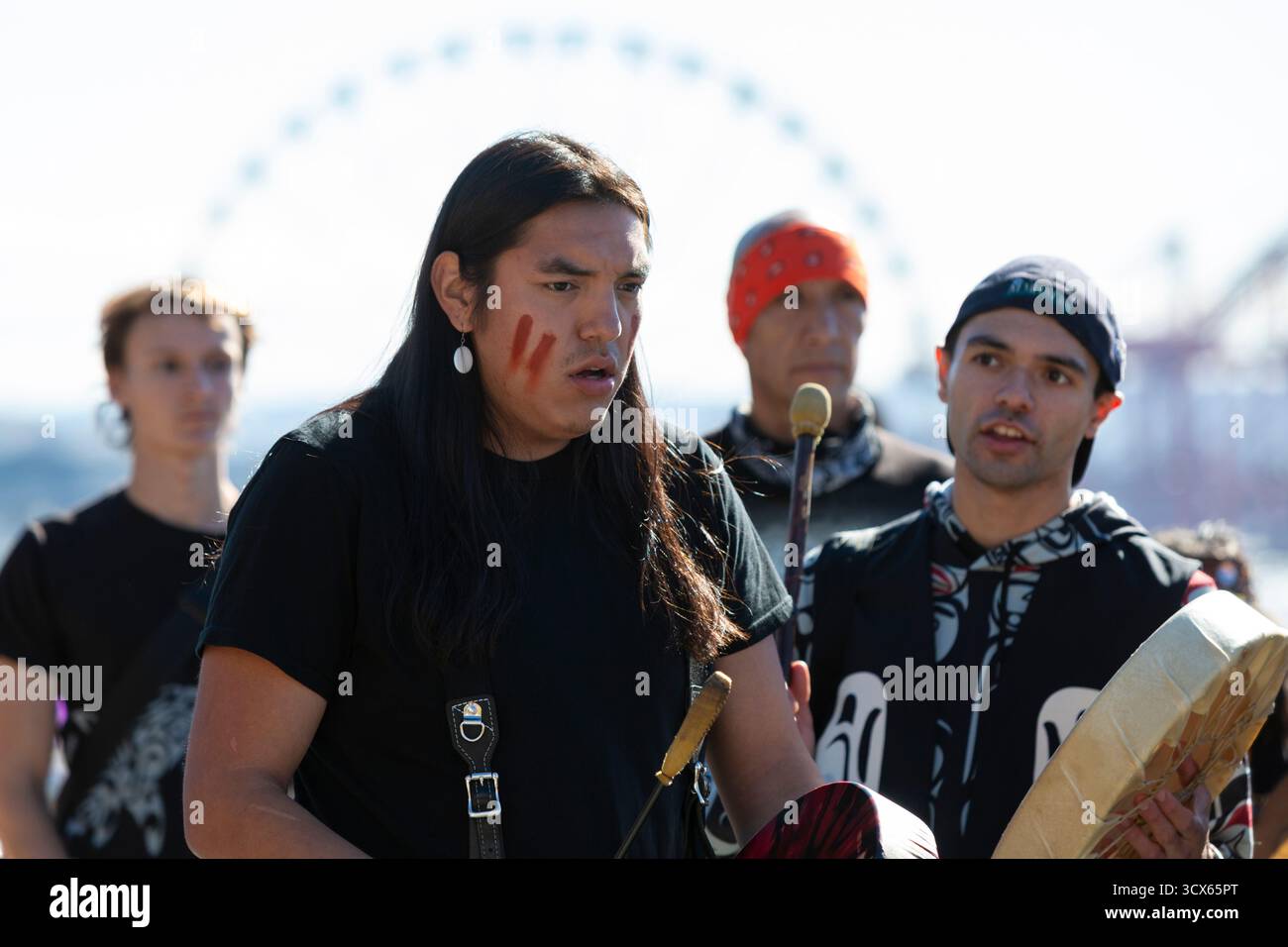 Seattle, Washington, USA. 13th October, 2025. Members of the Muckleshoot Tribe perform a song during a celebration of Indigenous People's Day at Victor Steinbrueck Park along Seattle’s waterfront. Seattle is one of the first U.S. cities to honor the presence of its Native peoples on this day instead of the traditional celebration of Columbus Day. Credit: Paul Christian Gordon/Alamy Live News Stock Photo