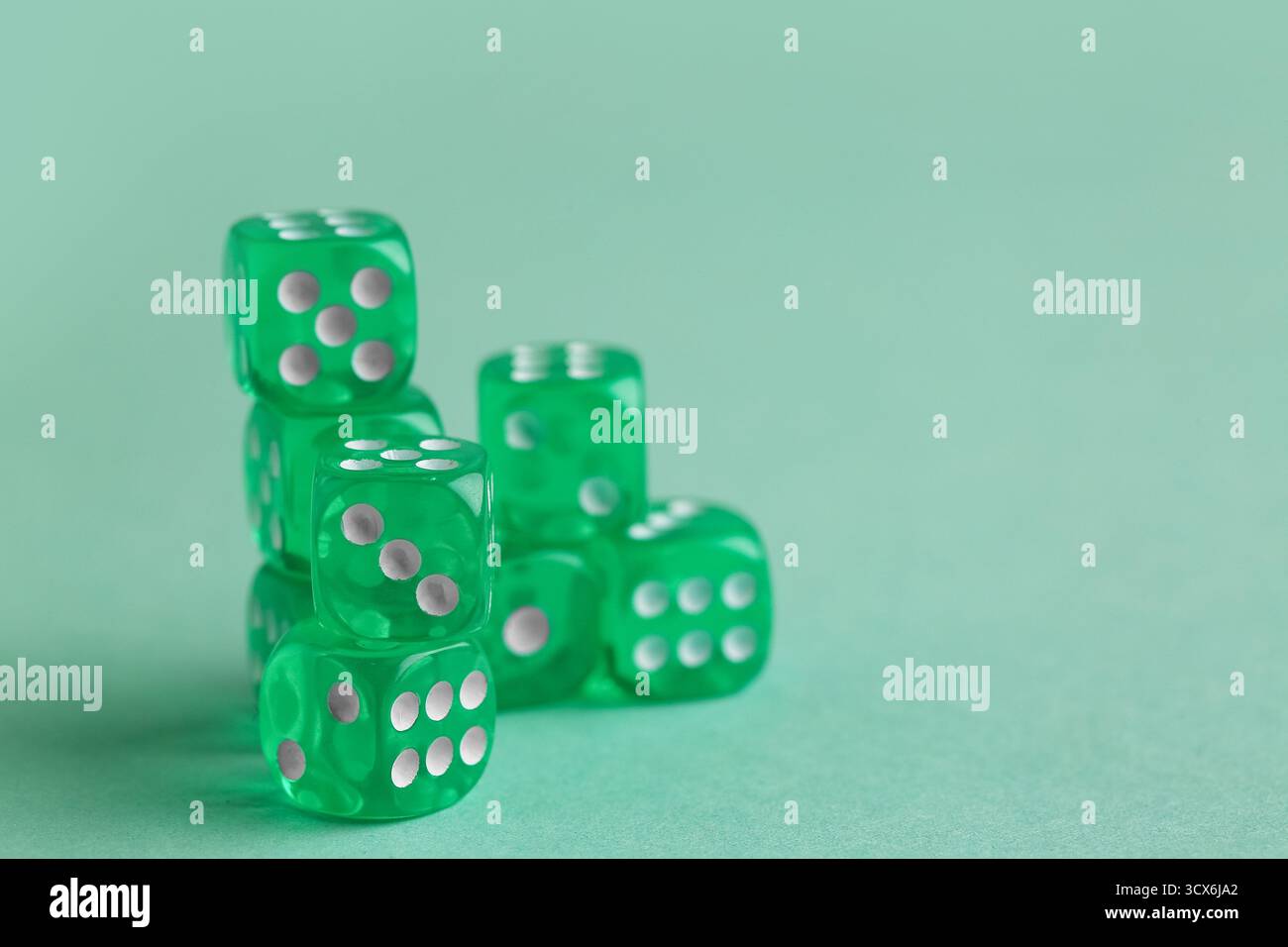 Green game dices on turquoise background Stock Photo