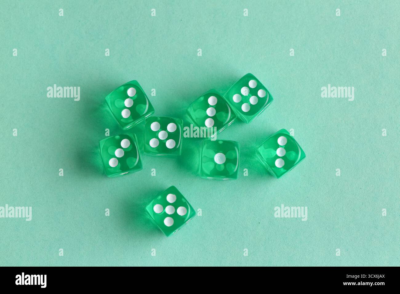 Green game dices on turquoise background Stock Photo