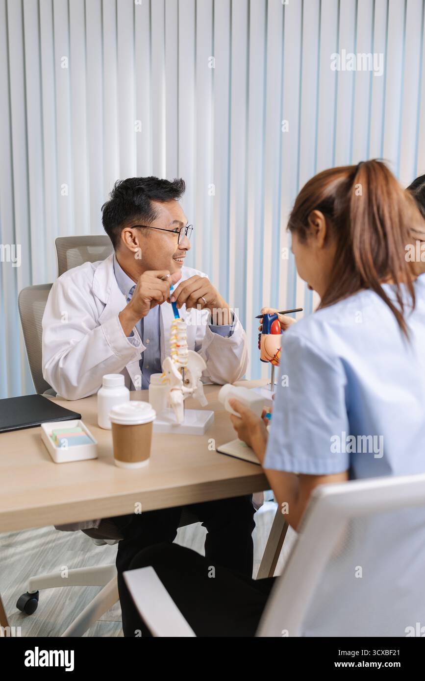 Team of doctors and nurses collaborating in a clinical environment, reviewing treatment options and sharing medical opinions to provide effective pati Stock Photo