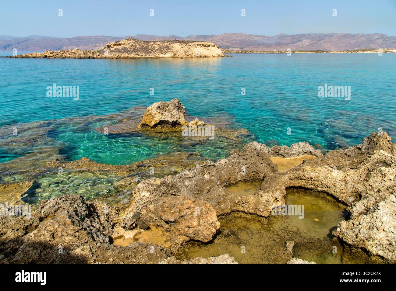 Serene coastal landscape with clear turquoise waters and majestic ...