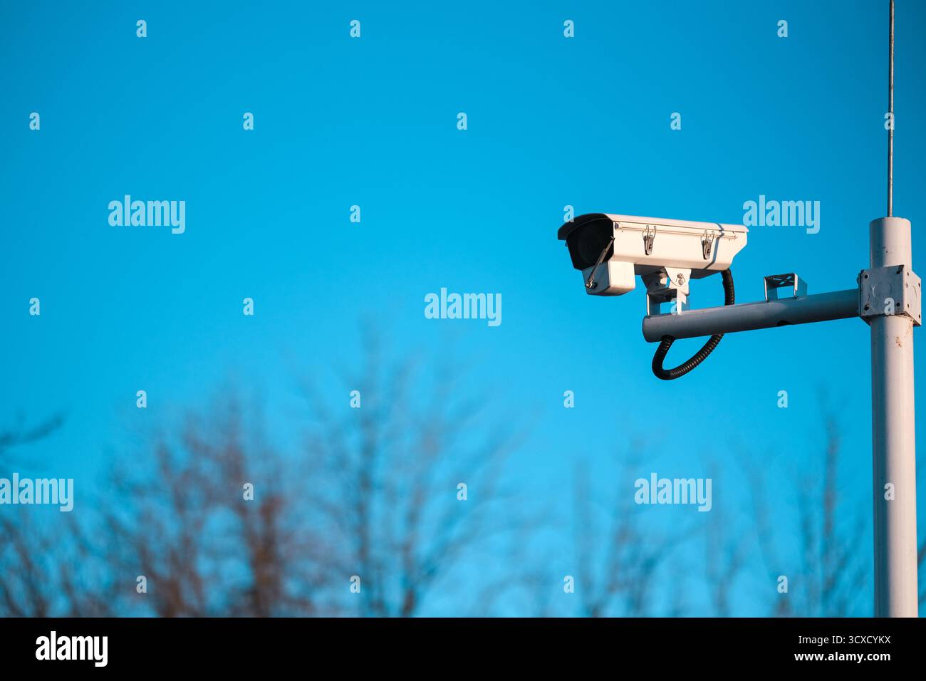 CCTV Camera on Blue Sky Background Stock Photo