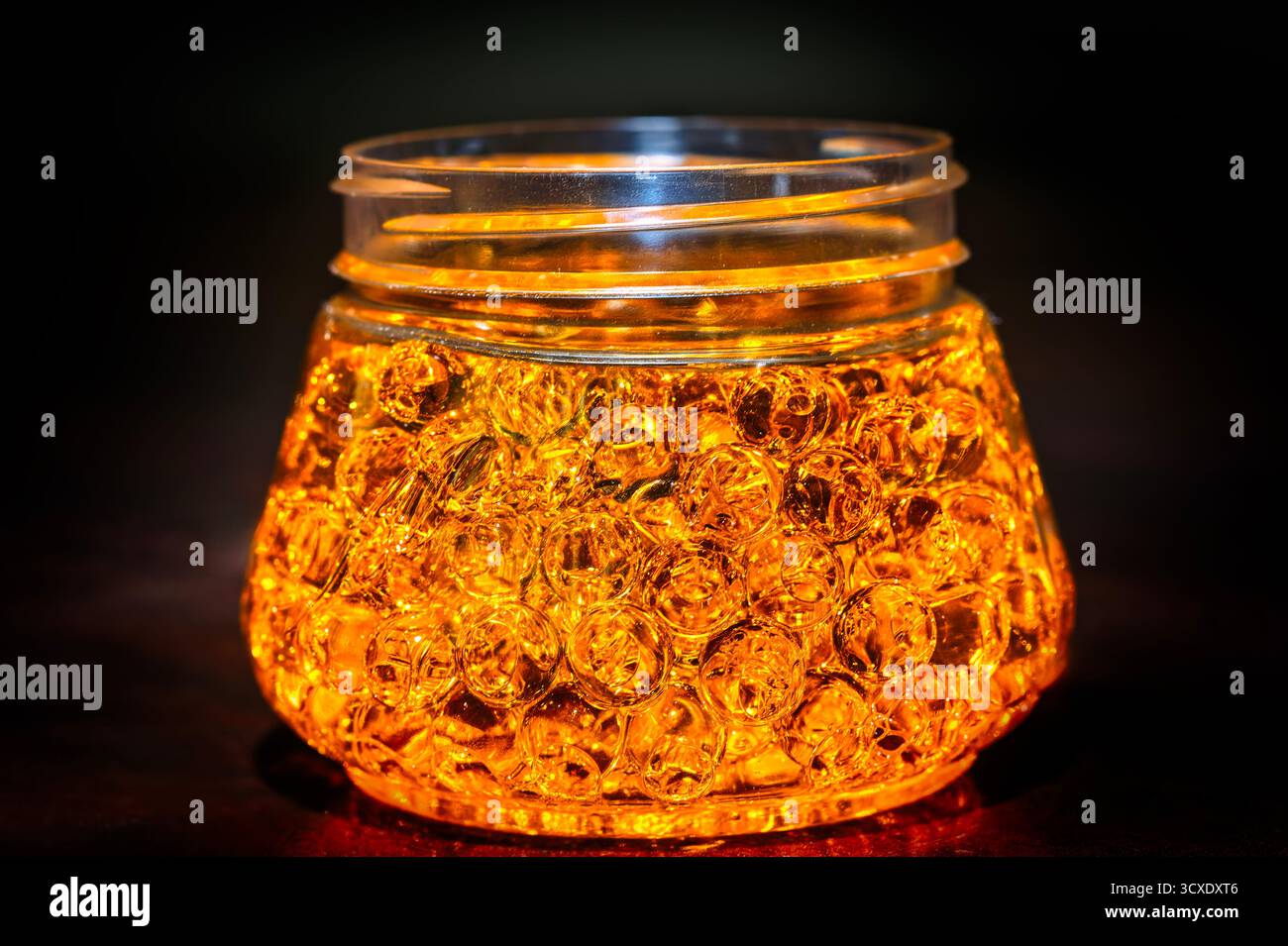 reflective beads gold in color, illuminated in a jar, design elements ...