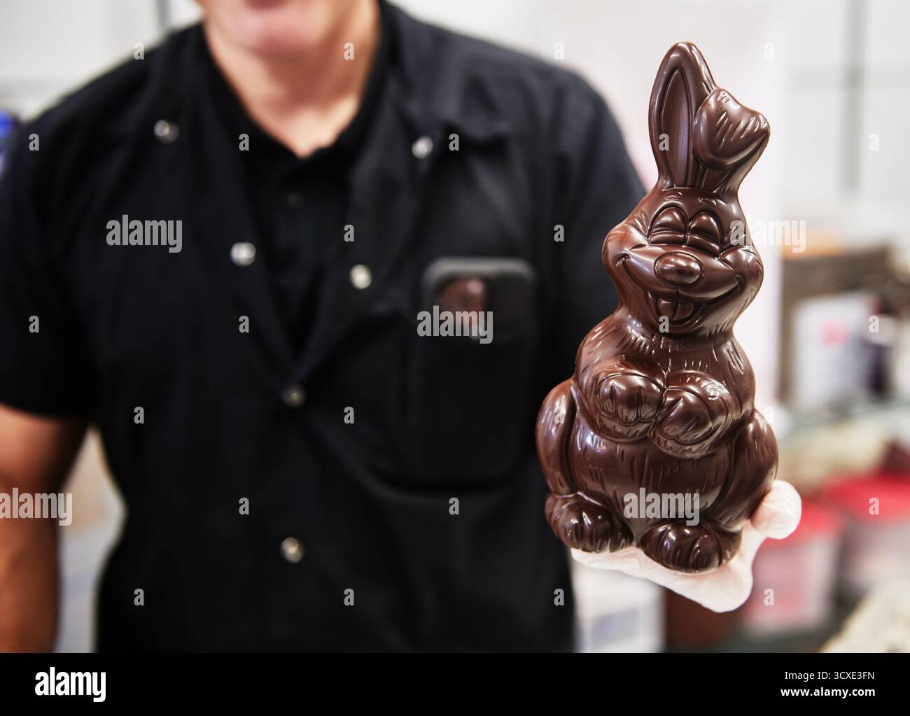 man holding a chocolate Easter bunny Stock Photo
