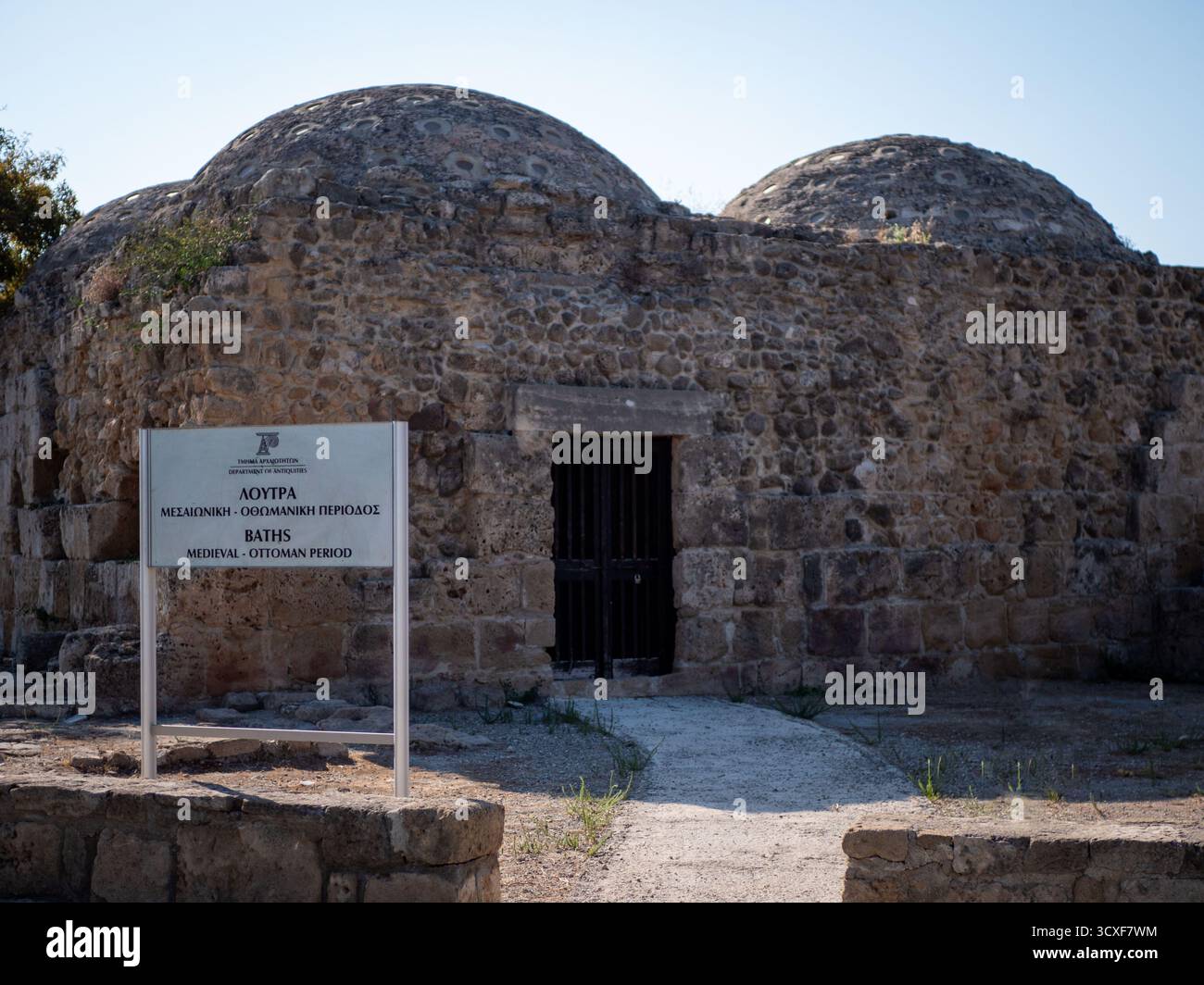 A stone wall and gate in the ruins of an ancient city reveal the ...