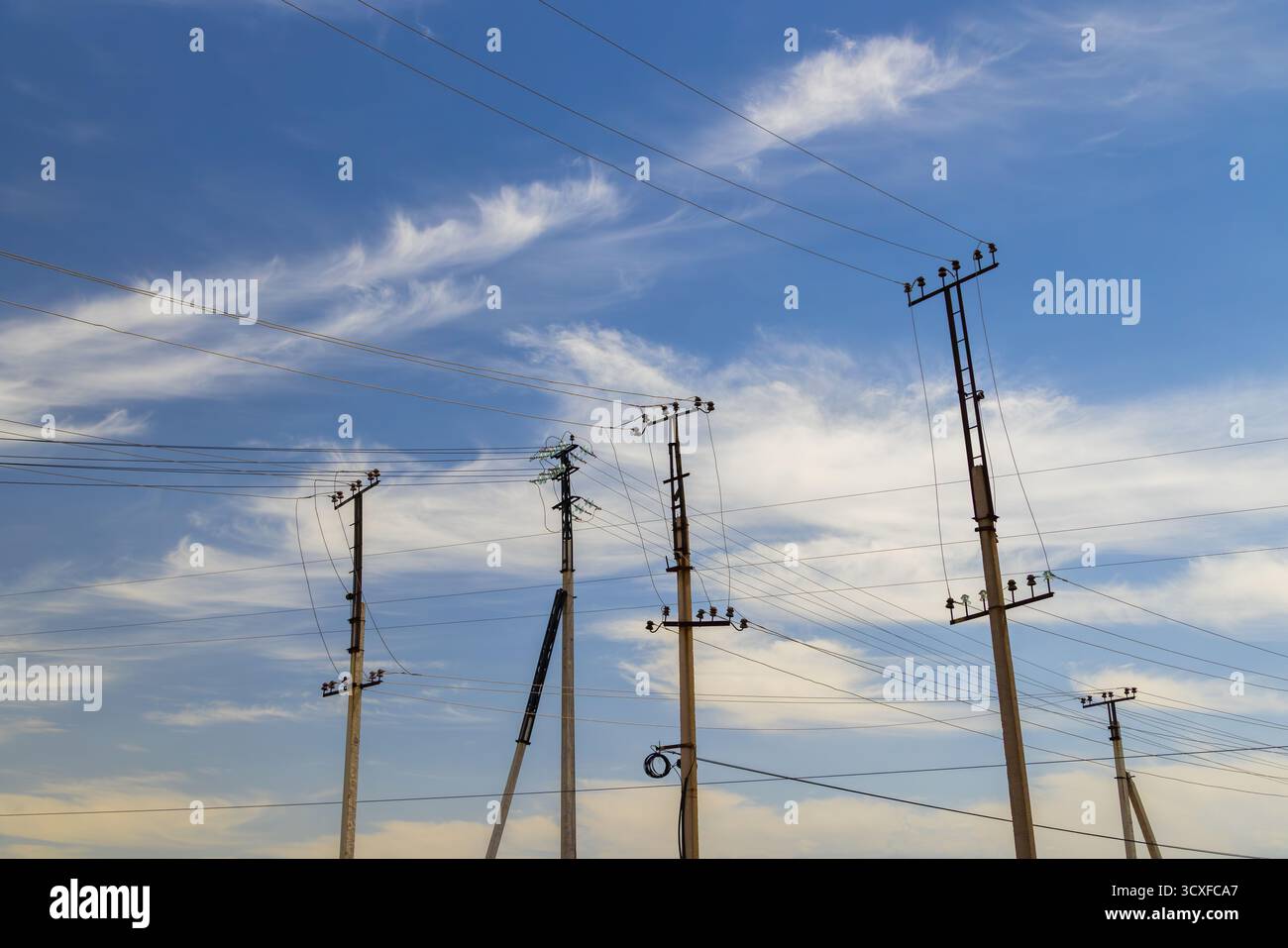 Utility poles and electrical wires under blue sky Stock Photo - Alamy