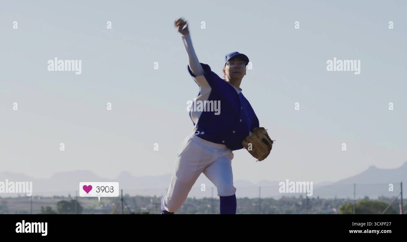 Pitching lone baseball player releasing baseball on field under clear sky, with leather glove Stock Photo