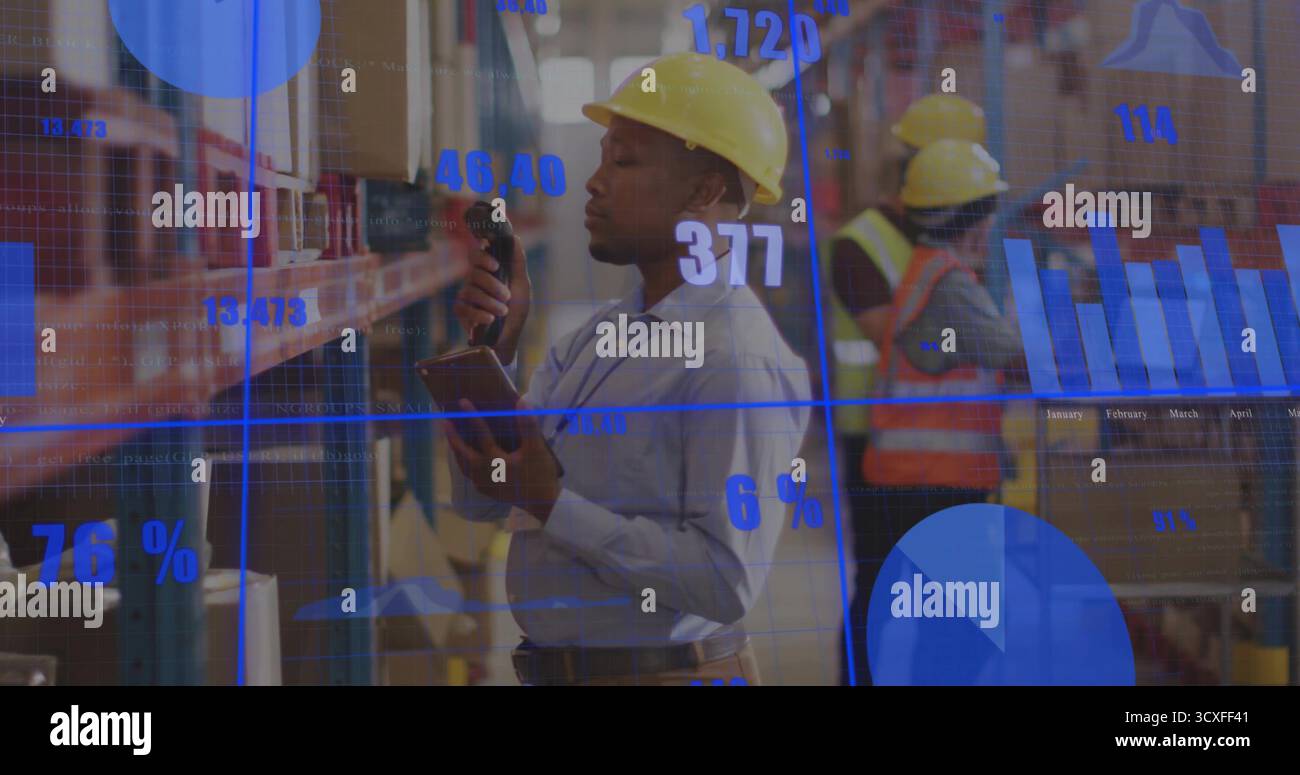 Using barcode scanner, worker wearing hard hat scanning box in warehouse aisle, with analytics Stock Photo