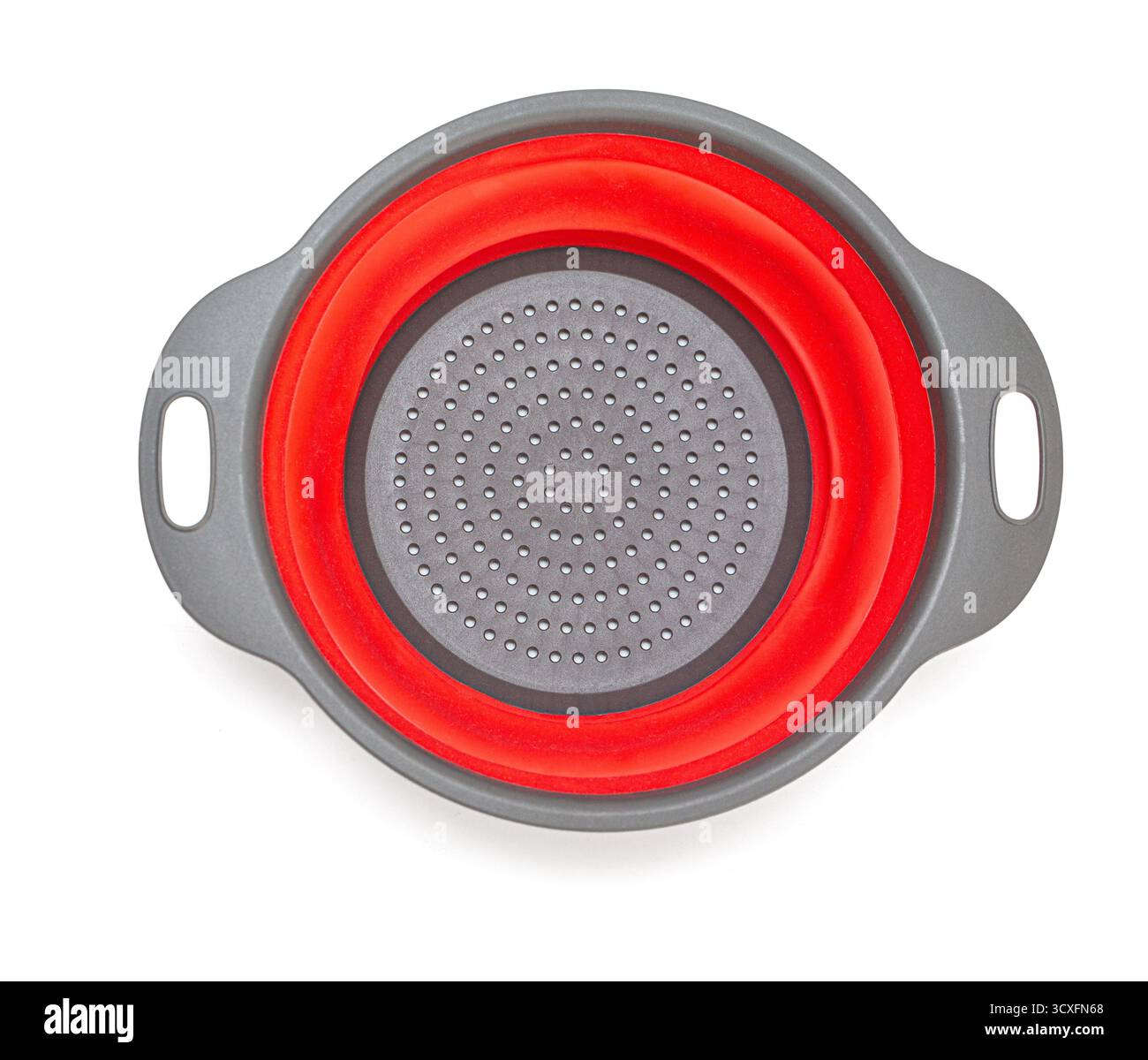 Kitchen colander with a red silicone base expanding, isolated on white background Stock Photo